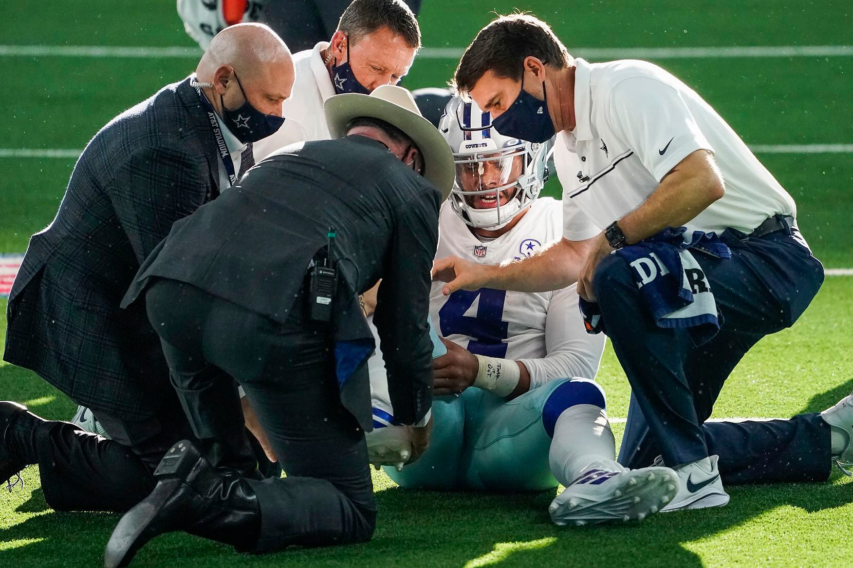 Dallas Cowboys quarterback Dak Prescott receives medical attention after being injured on a tackle by New York Giants cornerback Logan Ryan during the third quarter of an NFL football game at AT&T Stadium on Sunday, Oct. 11, 2020, in Arlington. Prescott was injured o the play when Ryan came down on his right leg and left the game. (Smiley N. Pool/The Dallas Morning News)