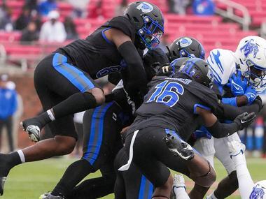 Memphis wide receiver Gabriel Rogers (9) is brought down by SMU safety Ahmaad Moses (16),...