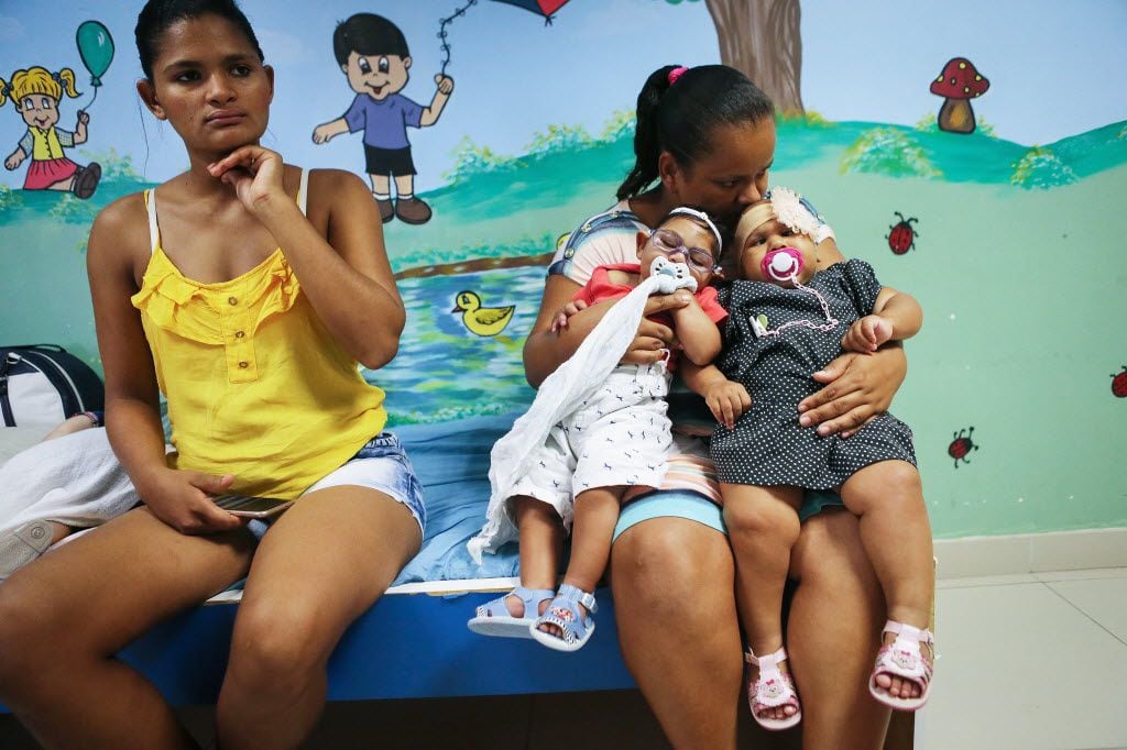 RECIFE, BRAZIL - JUNE 02:  Babies with microcephalia are held by a mother as she allows...