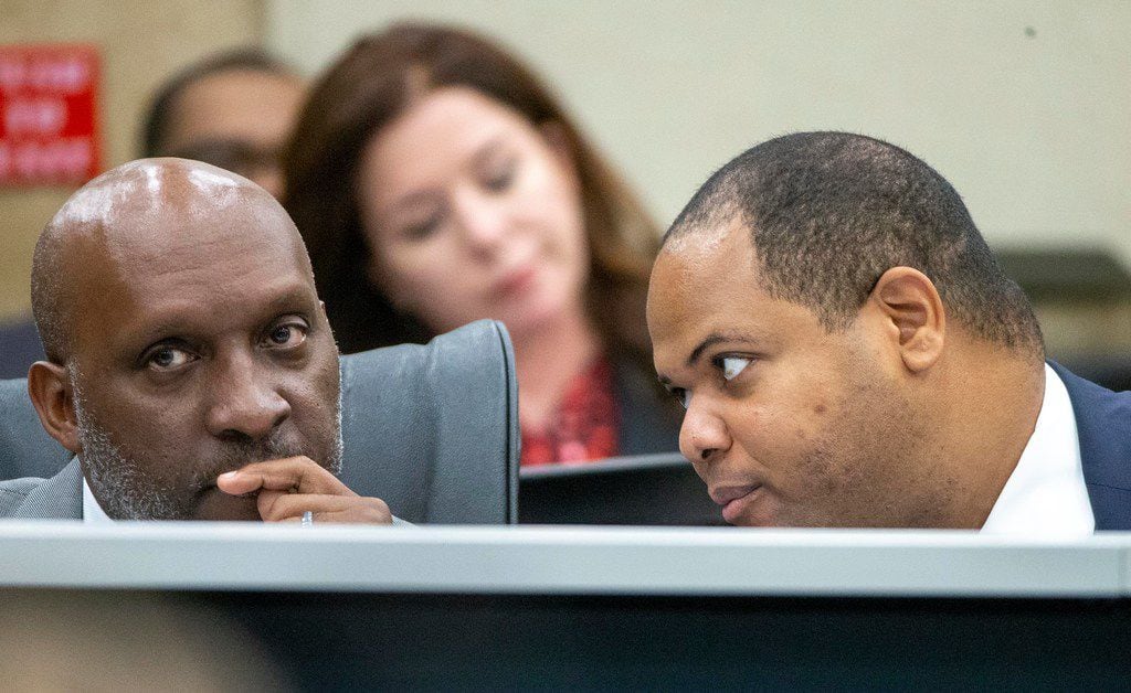 Dallas City Manager T.C. Broadnax, left, listens to Mayor Eric Johnson, right, during a City...