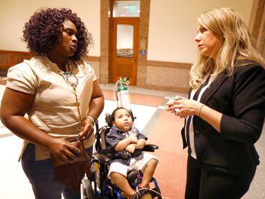 Linda Badawo of Mesquite, Texas and her 3 yr-old son D'ashon Morris (left) visit with Flower...
