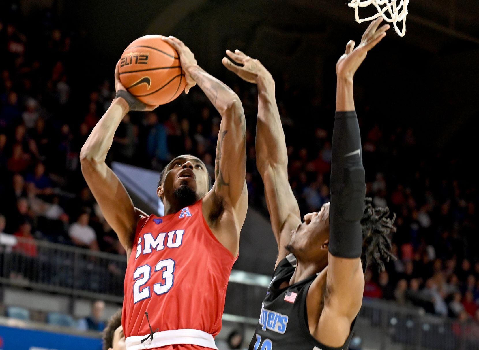 SMU guard Michael Weathers (23) shoots on Memphis forward DeAndre Williams (12) in the...