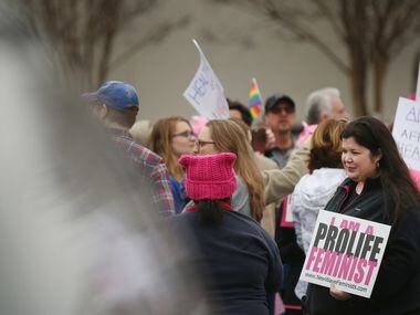 Rachel Lamb, of Richardson, Texas, who is part of the group New Wave Feminists, speaks to a...