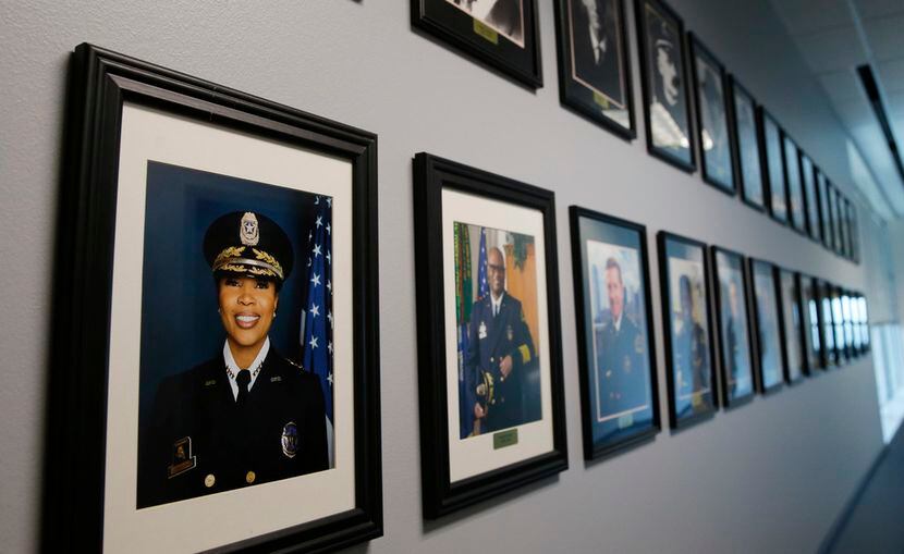 Dallas Police Chief U. Renee Hall's portrait next to past Dallas Police Chief's in a hallway...