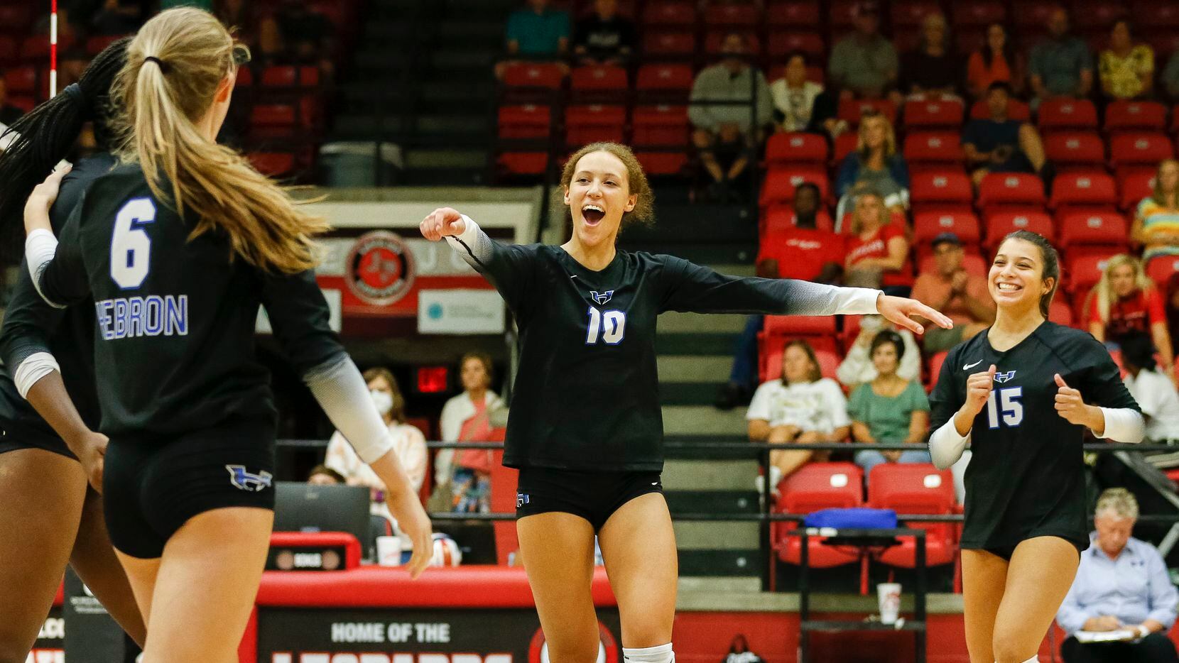 Hebron setter Harmony Sample (10) celebrates with teammates after a point during a...