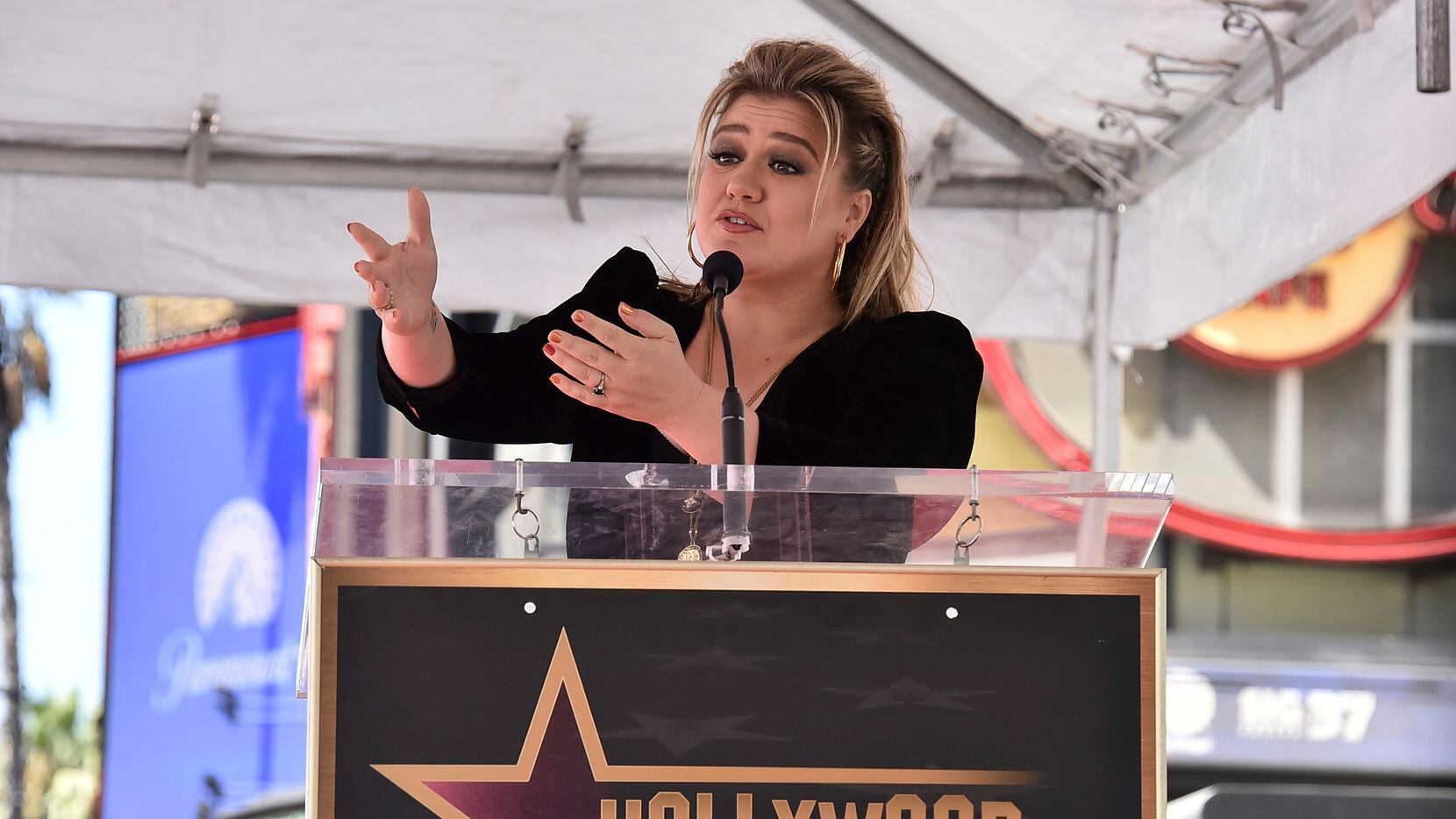 Singer and talk show host Kelly Clarkson speaks during a ceremony honoring her with a new...