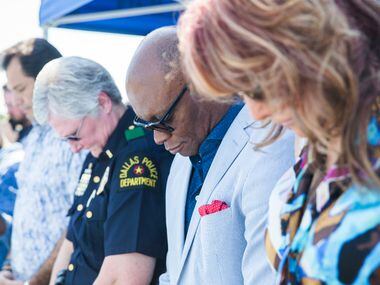 Basketball legend Nancy Lieberman (right) and former Dallas Police Chief David Brown pray as...