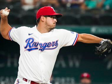 Texas Rangers starting pitcher Dane Dunning delivers during the first inning against the...