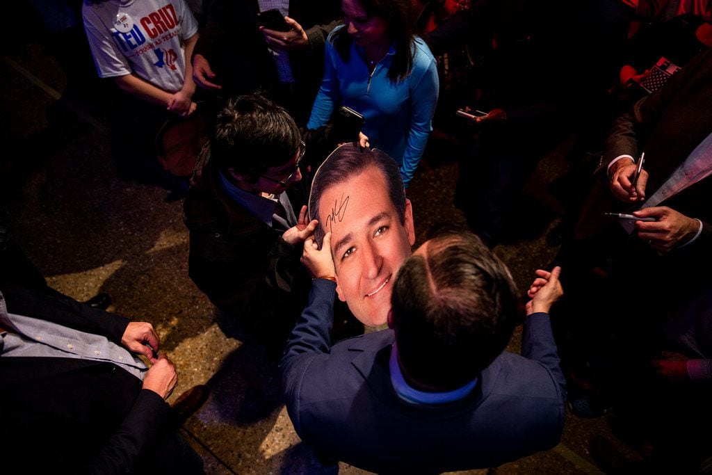 Senator Ted Cruz signs a cutout of his head following a campaign rally at Cendera Center in...