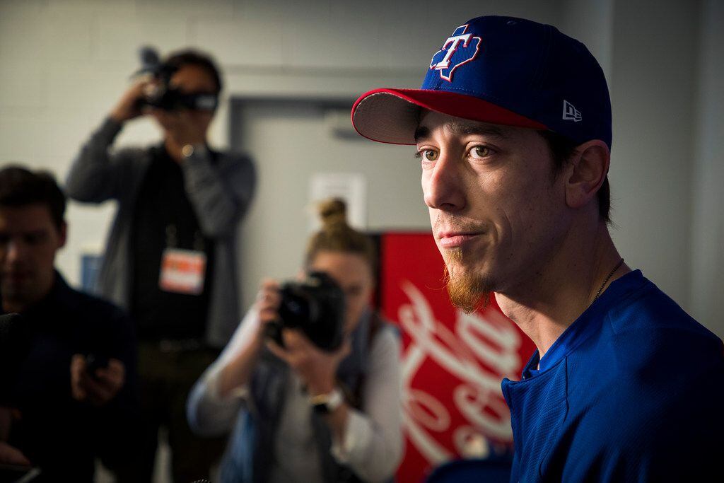 Texas Rangers pitcher Tim Lincecum addresses the media before a spring training workout at...