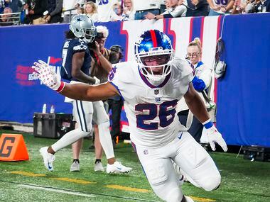 New York Giants running back Saquon Barkley (26) celebrates after scoring on a touchdown ...