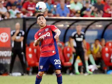 FC Dallas forward Alan Velasco (20) heads the soccer ball during the first half as FC Dallas...