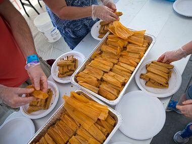 Volunteers unwrap tamales at the Western Days Festival World Tamale Eating Championship...