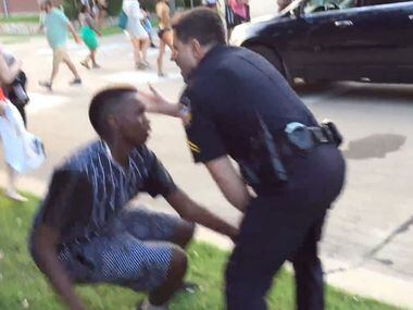 McKinney police officer Eric Casebolt slaps a black teen in the head as he pushes him to the...