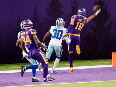 Minnesota Vikings wide receiver Adam Thielen (19) catches a 2-yard touchdown pass ahead of Dallas Cowboys cornerback Anthony Brown (30) during the second half of an NFL football game, Sunday, Nov. 22, 2020, in Minneapolis. (AP Photo/Jim Mone)