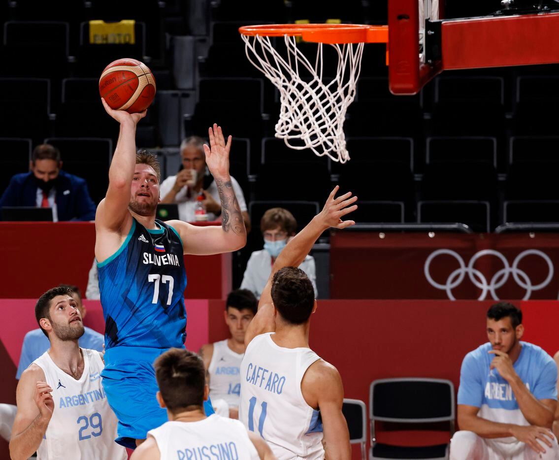 Slovenia’s Luka Doncic (77) shoots over Argentina’s Francisco Caffaro (11) in the second half of play during the postponed 2020 Tokyo Olympics at Saitama Super Arena on Monday, July 26, 2021, in Saitama, Japan. Slovenia defeated Argentina 118-100. (Vernon Bryant/The Dallas Morning News)