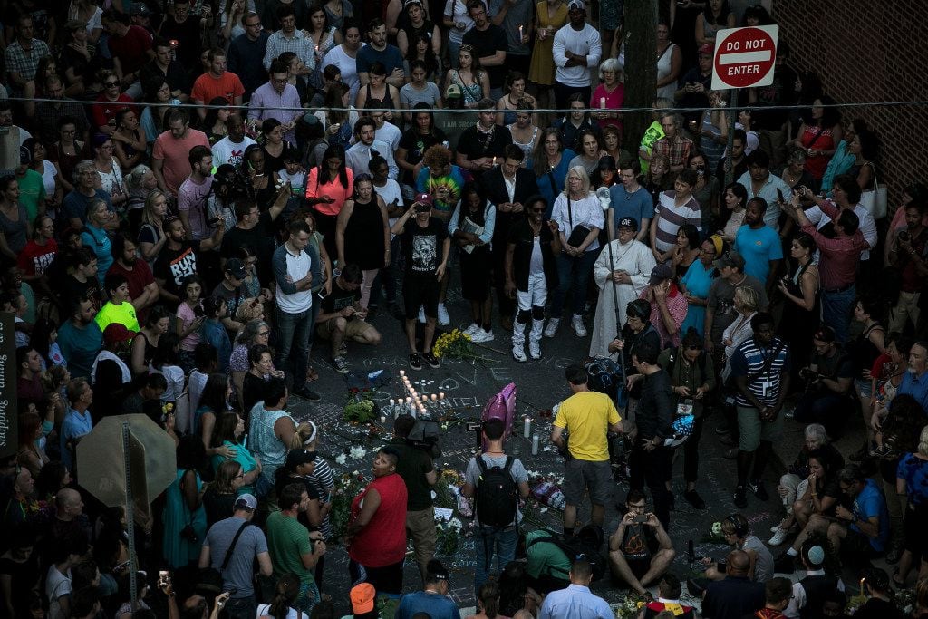 A vigil at the site where on Saturday a car plowed into a group of counter-protesters after a "Unite the Right" rally by white nationalist groups, in Charlottesville, Va., Aug. 13, 2017. A woman was killed and at least 19 were injured, and the car's alleged driver has been charged with second-degree murder. (Edu Bayer/The New York Times)