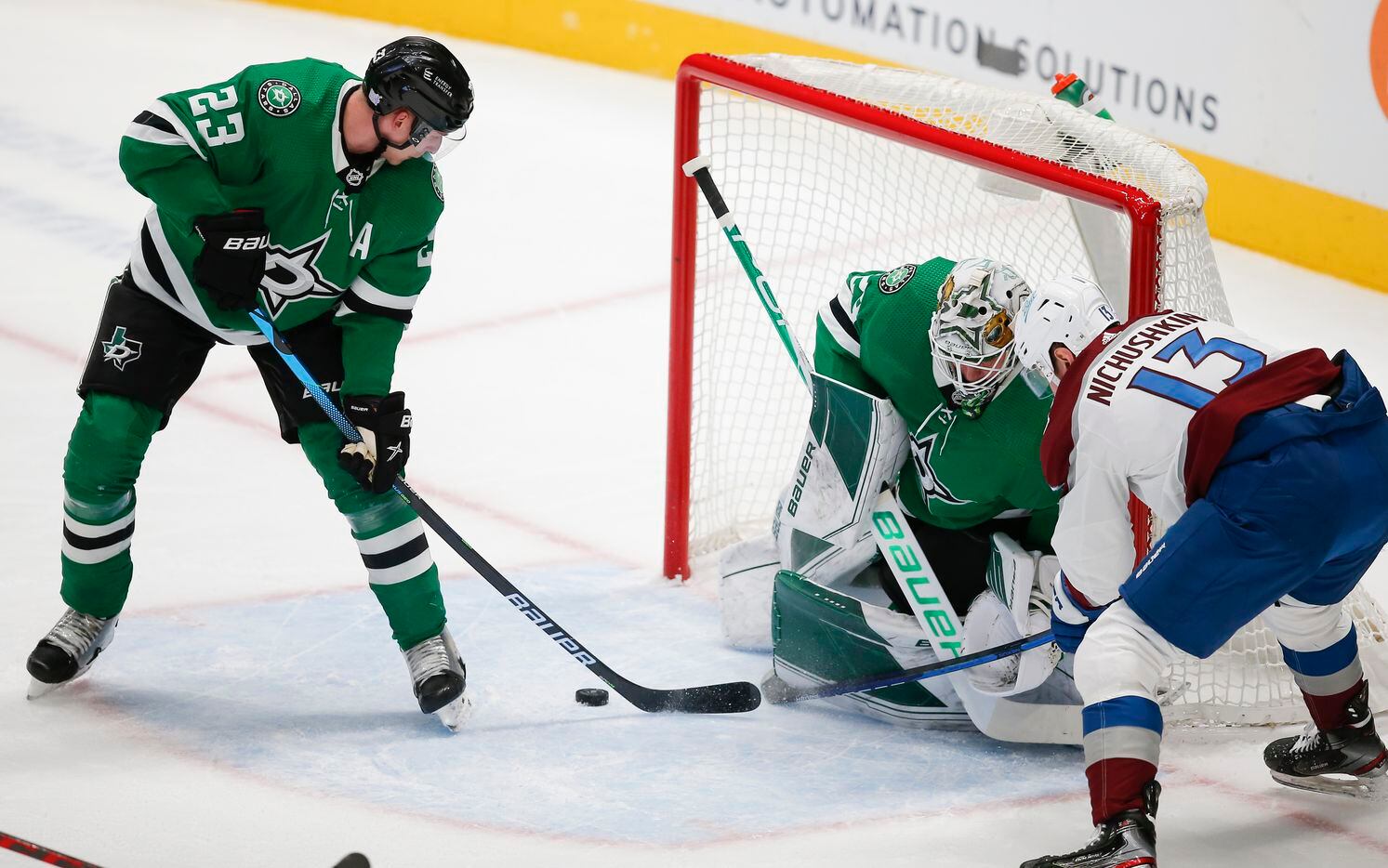 Colorado Avalanche forward Valeri Nichushkin (13) looks for the rebound as Dallas Stars defenseman Esa Lindell (23) and goaltender Jake Oettinger (29) defend during the first period of an NHL hockey game in Dallas, Friday, November 26, 2021.