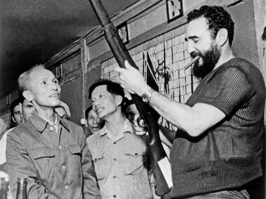 In this Sept. 1973 file photo, Cuban president Fidel Castro (R) looks at a rifle during a...