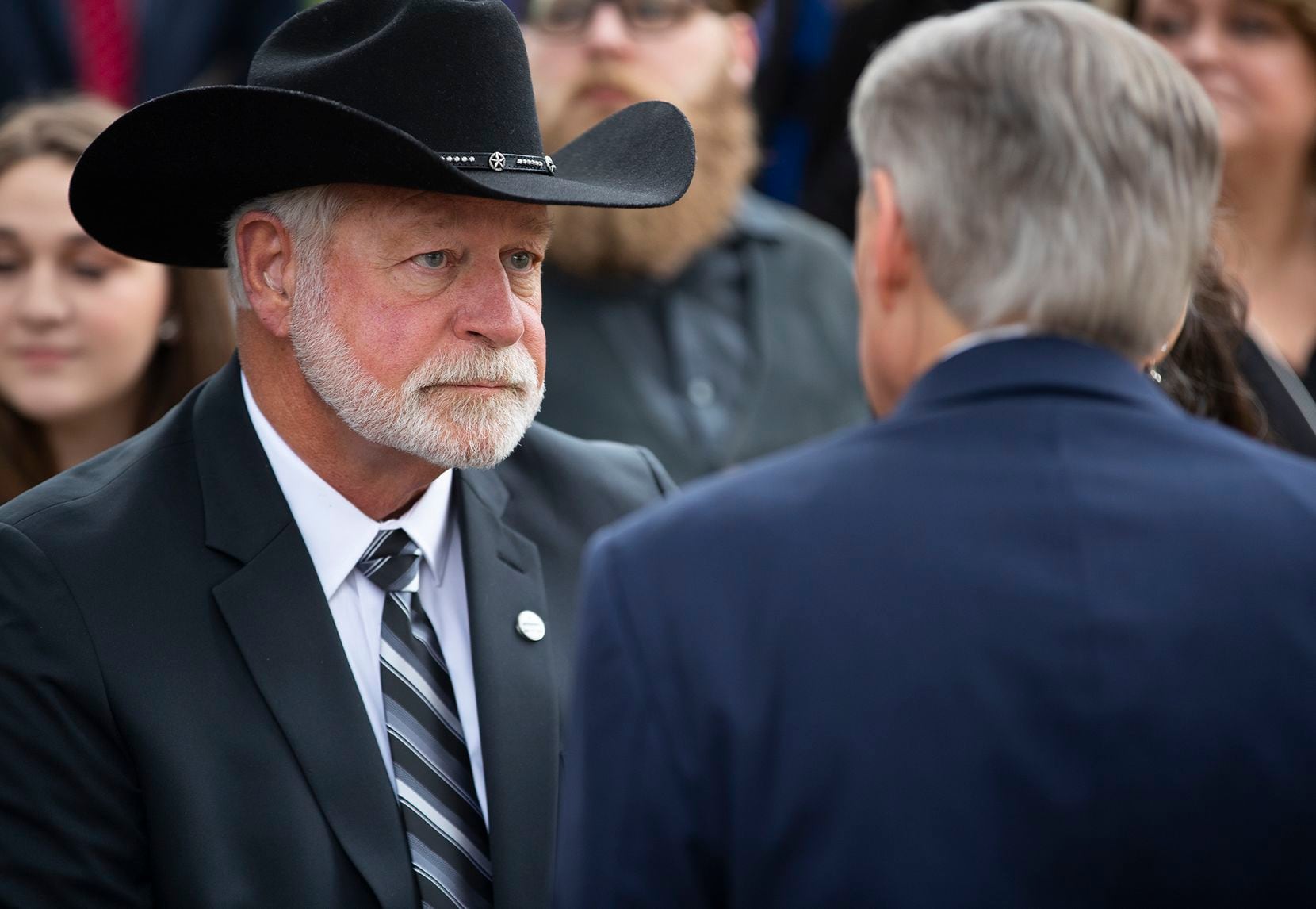 Jack Wilson, the firearms instructor and church deacon who shot and killed a gunman who opened fire at the West Freeway Church of Christ late last year, is shown conferring with Gov. Greg Abbott before he received a newly created civilian honor, the Governor's Medal of Courage, in a January ceremony at the Governor's Mansion. 