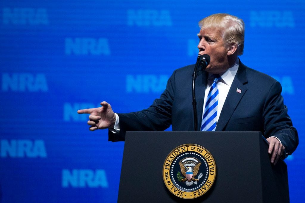 President Donald Trump makes finger gun to make a point while addressing the NRA-ILA Leadership Forum at the Kay Bailey Hutchison Convention Center on Friday, May 4, 2018, in Dallas. 