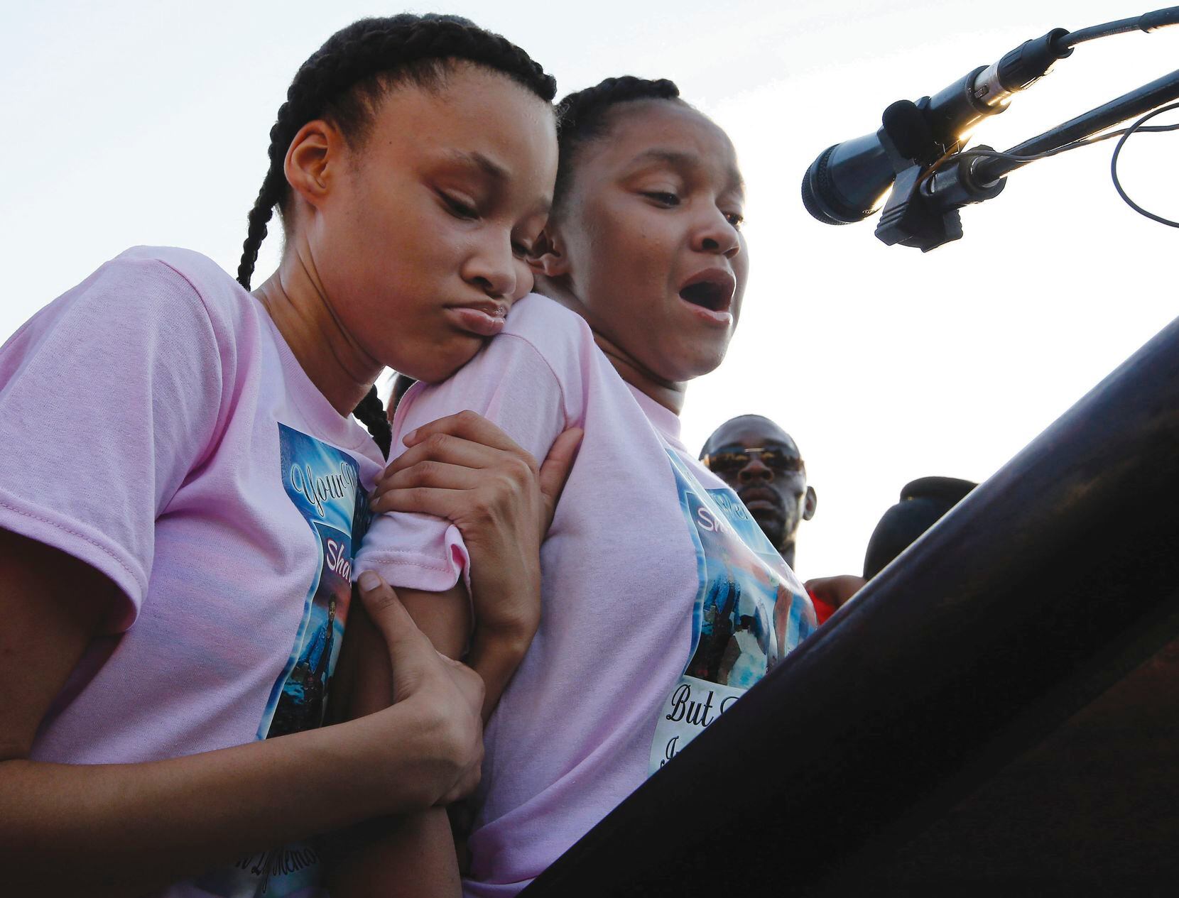 Kayla Randle (right), 14, with Shiniece Richards, 16, speaks during a vigil July 3 for their sister Shavon Randle, 13, who was killed and her body left in an abandoned East Oak Cliff home. The Lancaster girl was kidnapped and slain over stolen drugs that she had nothing to do with, police said.