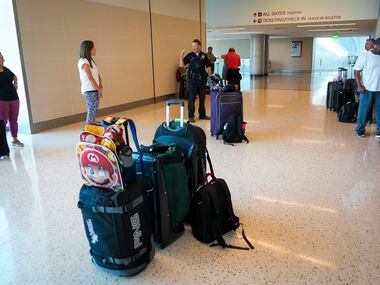 Dallas police direct passengers away from the ticketing hall at Dallas Love Field Airport on...