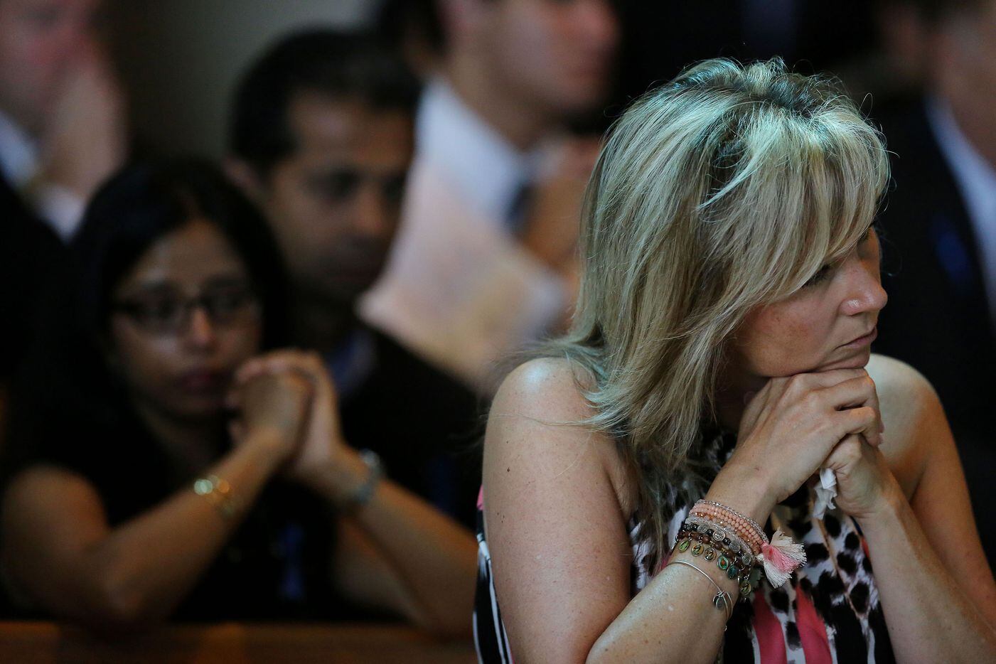 Worshippers mourn during the funeral for Dallas police sergeant Michael Smith.
