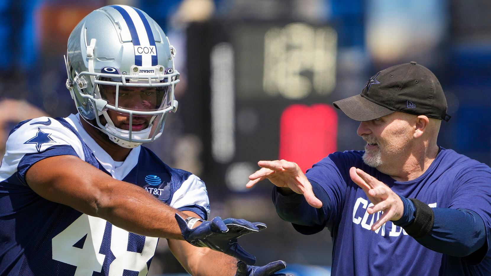 Dallas Cowboys defensive coordinator Dan Quinn works with linebacker Jabril Cox (48) during...