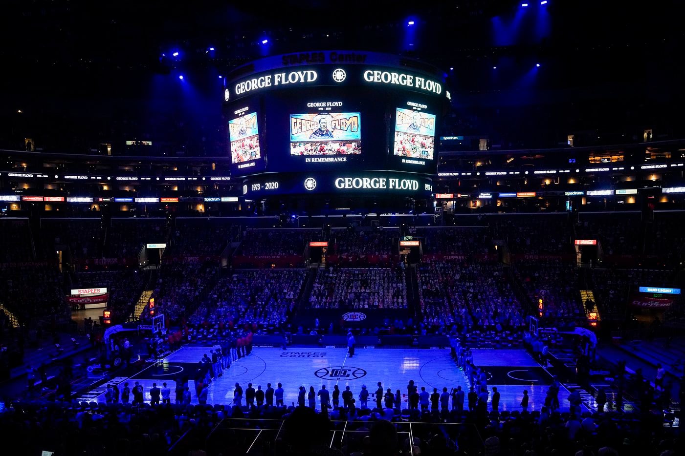 Dallas Mavericks and LA Clippers players and fans stand for a moment of silence in memory of George Floyd before n NBA playoff basketball game at Staples Center on Tuesday, May 25, 2021, in Los Angeles.