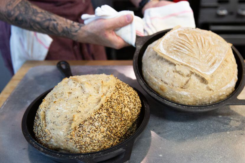 Matt Bresnan, head chef at Food Company, removes two loaves of bread in the Nonna kitchen in...