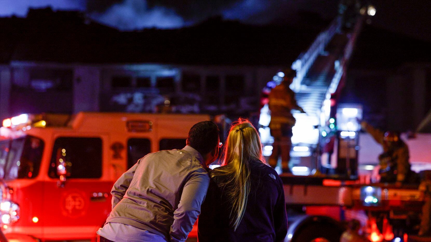 Jaime Castro (left) watches alongside his wife Catalina Nieto as Dallas Fire-Rescue respond...