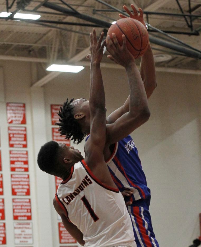 Duncanville forward Ronald Holland (1) shoots against the defense of Cedar Hill defender Jalen Ware-Williams (1) during first half action. The two teams played their District 11-6A boys basketball game at Cedar Hill High School in Cedar Hill on January 14, 2022. (Steve Hamm/ Special Contributor)