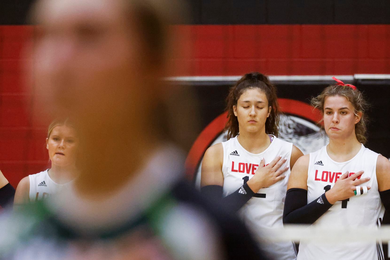 Lovejoy’s Hannah Gonzalez, second from right, closes her eyes as she take part in the...