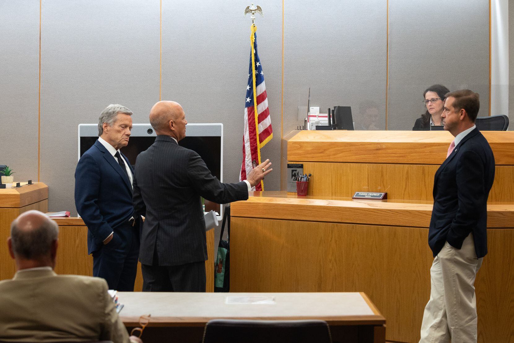 L-R: Defense lawyer Allan Fishburn, second from left, District Attorney John Creuzot,...