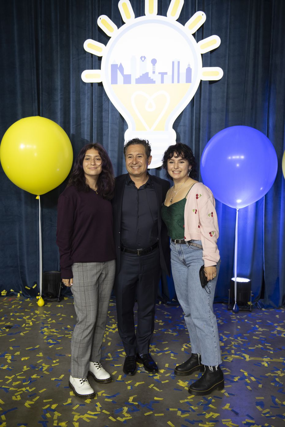 The Pitch’ judge, Jorge Corral stands with daughters Eva and Ali in the middle of yellow and...