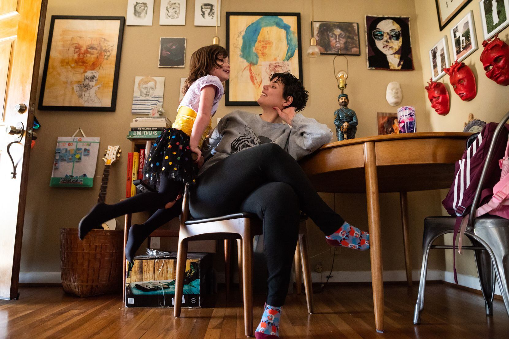 Violet, right, and her trans daughter Isa, speak to each other inside the living room of...