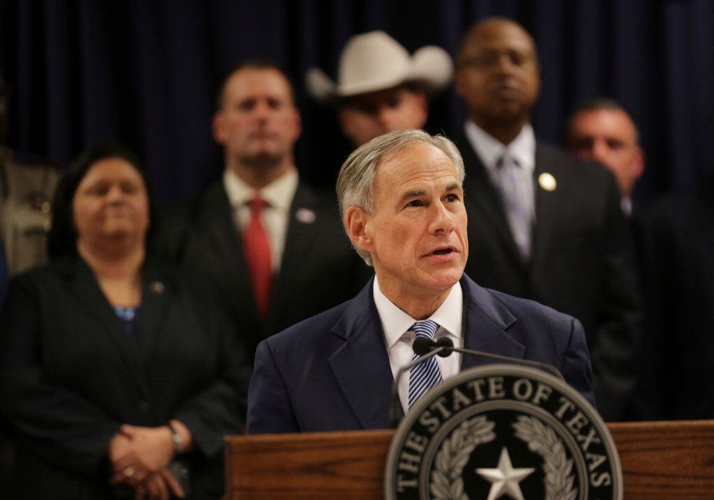 Surrounded by leadership of different law enforcement agencies, Texas Gov. Greg Abbott...