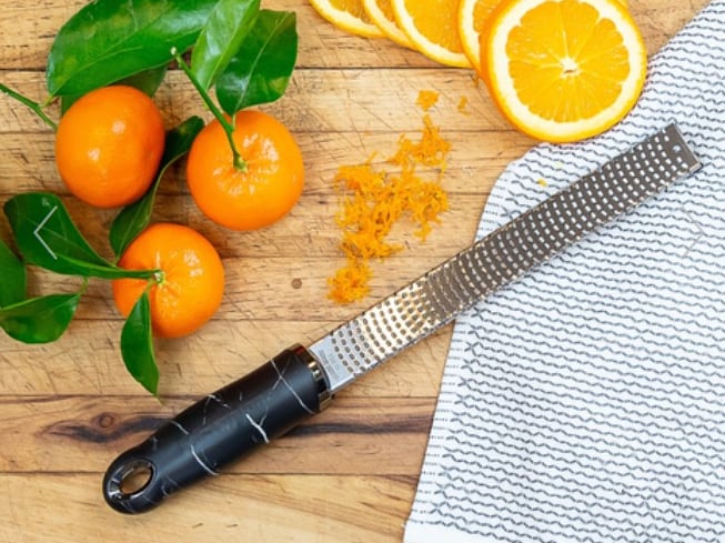 Zester kitchen tool with oranges