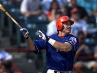 Texas Rangers' Rafael Palmeiro  hits a solo home run during the 8th inning against the...