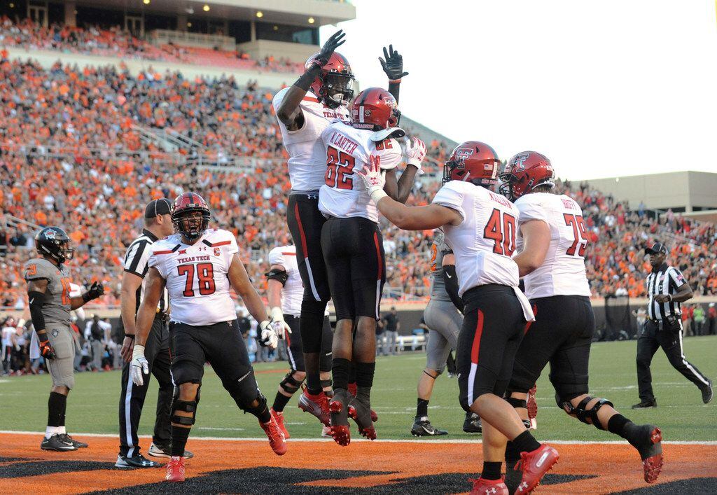 Texas Tech's Terence Steele (78), Connor Killian (40), Travis Bruffy (79) and T.J. Vasher celebrate a touchdown by KeSean Carter (82) during the first half of an NCAA college football game against Oklahoma State in Stillwater, Okla., Saturday, Sept. 22, 2018. Texas Tech won 41-17. (AP Photo/Brody Schmidt)