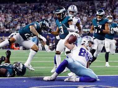 Dallas Cowboys tight end Dalton Schultz (86) slides into the end zone after running in a...