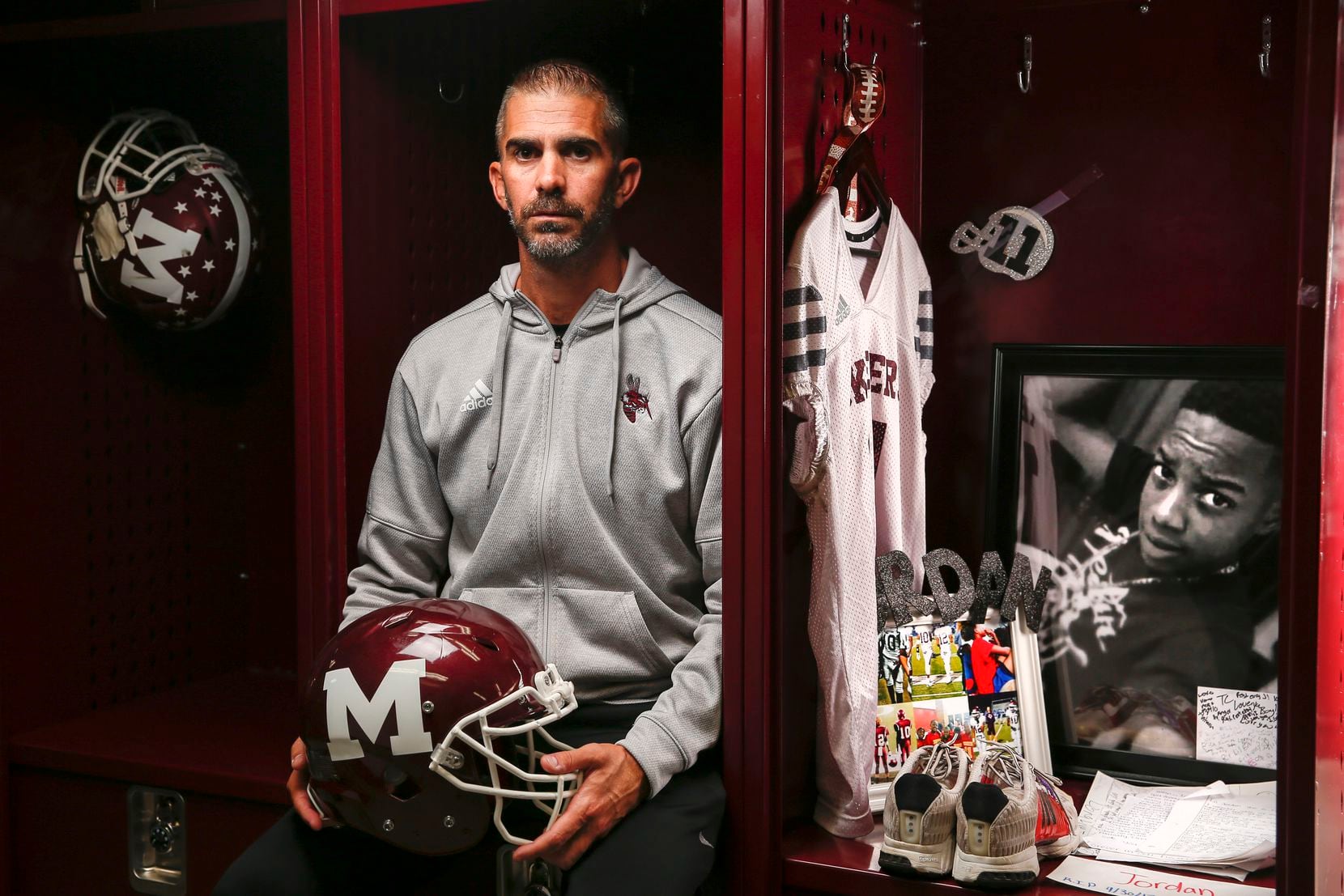 Mesquite football coach Jeff Fleener poses for a photograph next to the locker of former...