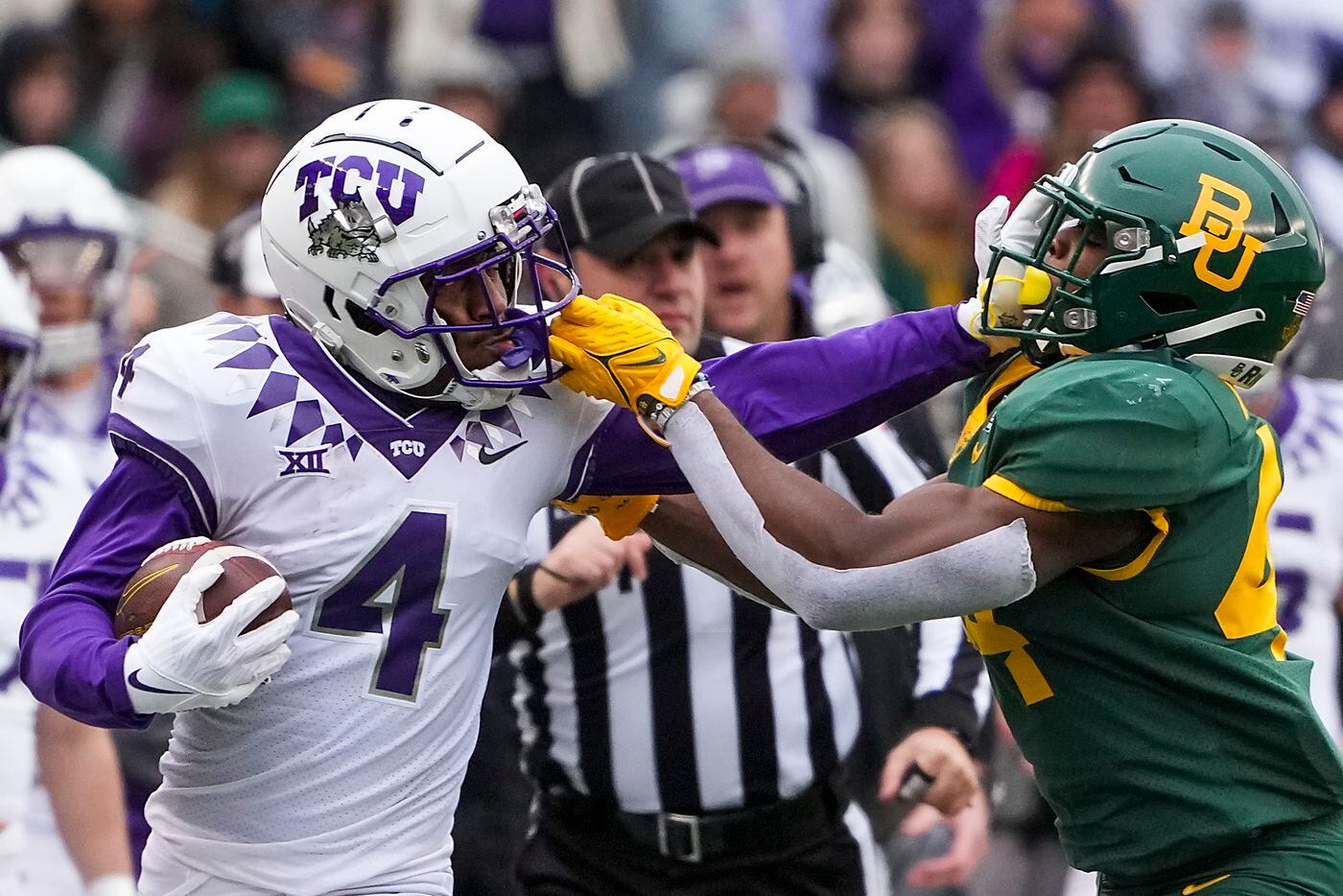 TCU wide receiver Taye Barber (4) is pulled down by Baylor linebacker Josh White (44) on a...