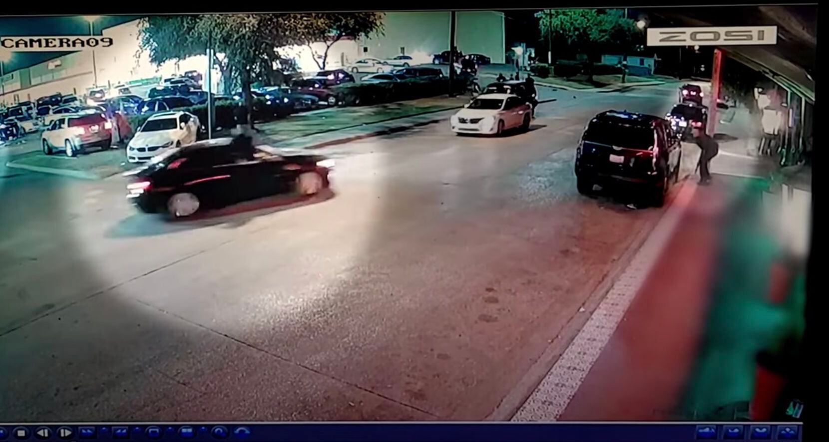 Surveillance footage released by police Monday shows a security guard fire into the air...