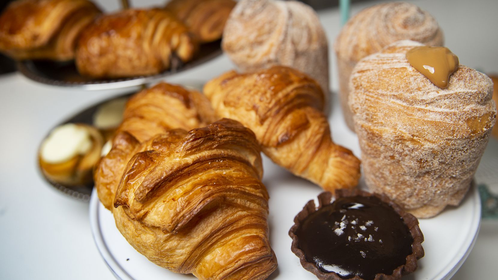Pastries, including croissants, chocolate caramel tart and churro cruffins, at La Casita...