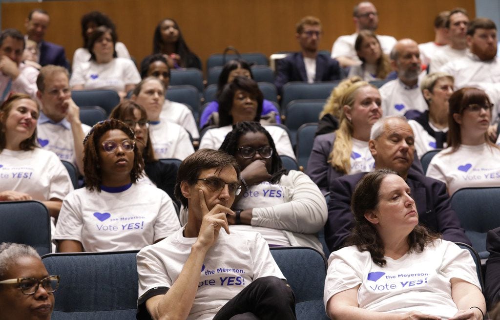 Meyerson Symphony Center supporters listen to the city council speak during a city council...