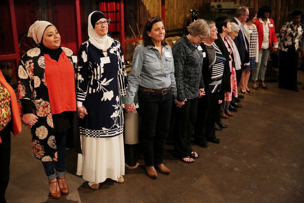 Attendees hold hands as rabbi Nancy Kasten prays at the conclusion of the thirty-sixth annual National Day of Prayer Luncheon at Eddie Deen's Ranch in Dallas Thursday May 4, 2017. The luncheon was hosted by The Thanks-Giving Foundation and its Interfaith Council. The program was titled "Prayer in the 21st Century: A Journey of the Timeless and Thought-Provoking.