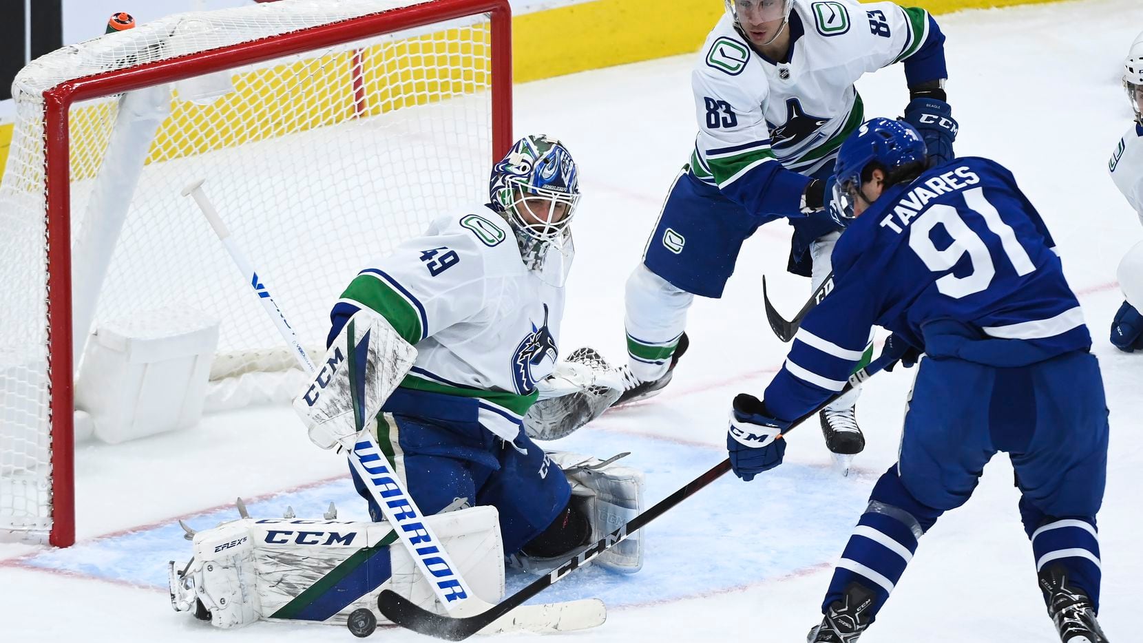 Vancouver Canucks goaltender Braden Holtby (49) stops Toronto Maple Leafs centre John...