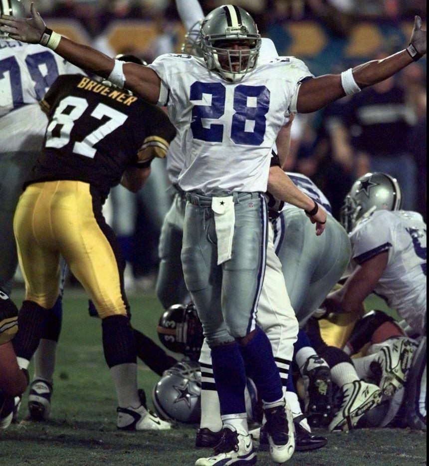 Dallas Cowboys' Darren Woodson celebrates during the third quarter after the Cowboys stopped...